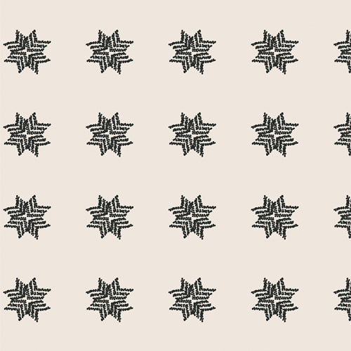 A bold blender fabric sold online by Dolly Lou fabrics. Patterned in cream with black star like points