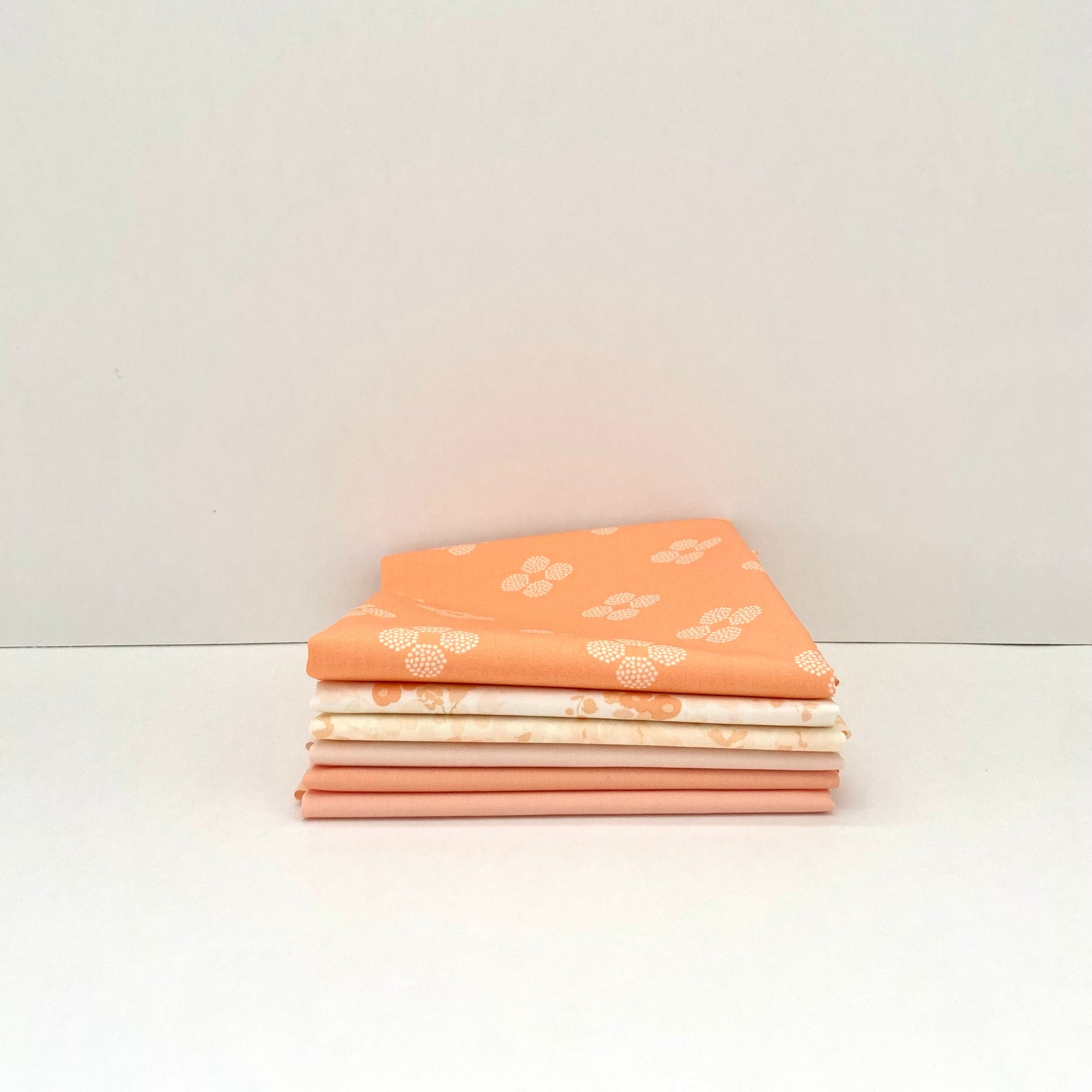 Fabric bundle sold by Dolly Lou Fabrics, contains Art Gallery Fabrics Nectarine Fusion and Pure Solids