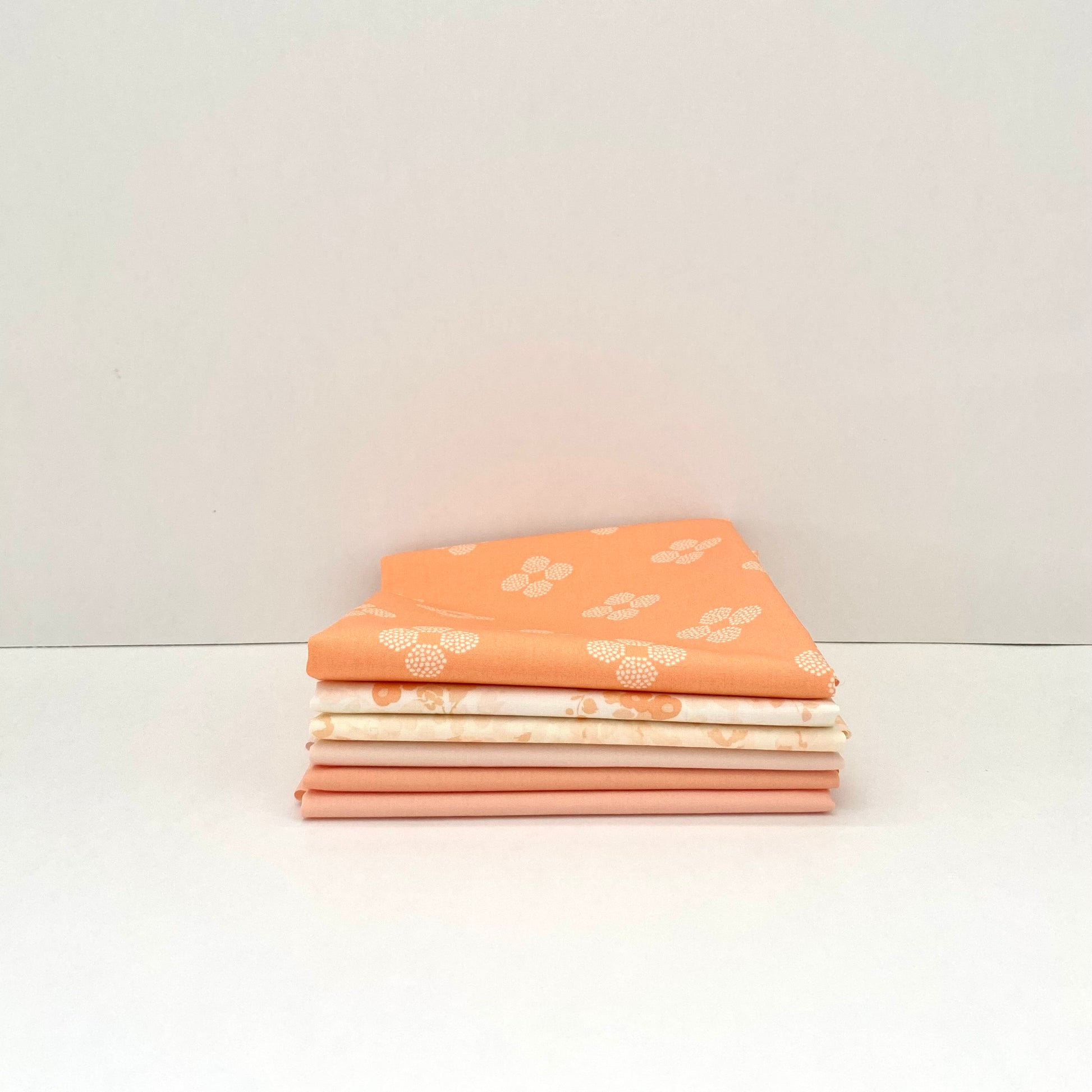 Fabric bundle sold by Dolly Lou Fabrics, contains Art Gallery Fabrics Nectarine Fusion and Pure Solids 
